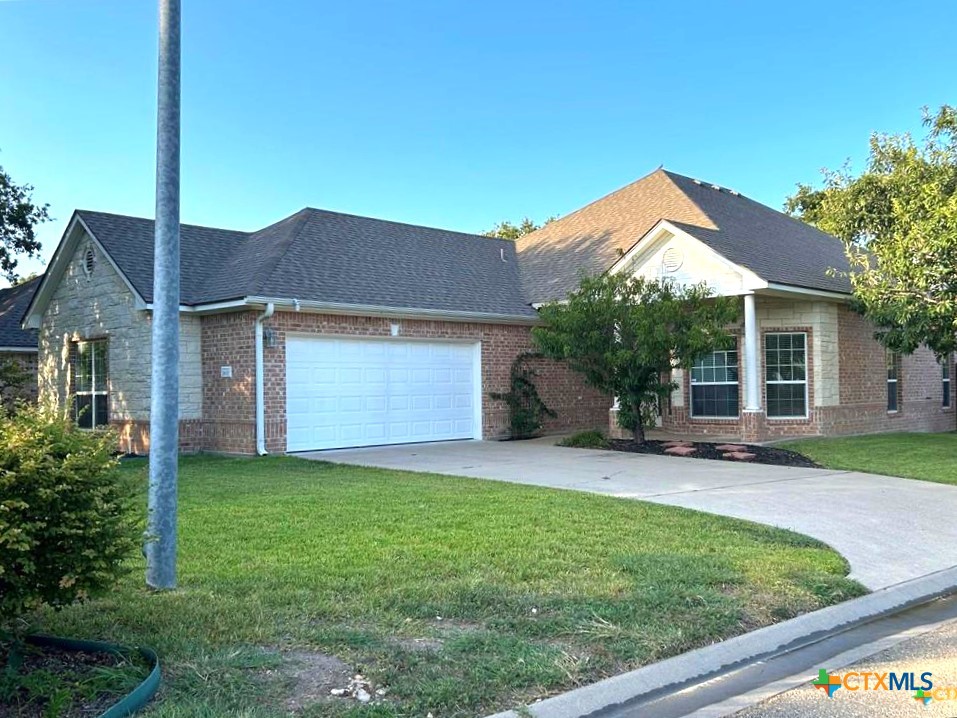 a view of a house with a yard and sitting area