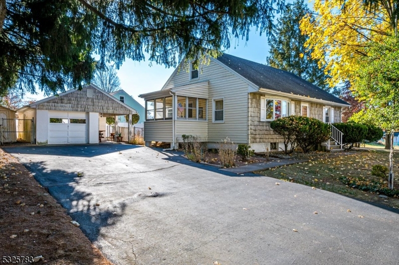 a front view of a house with a yard and potted plants