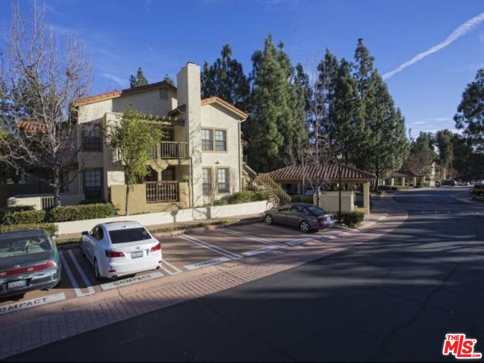 a view of a street with cars parked