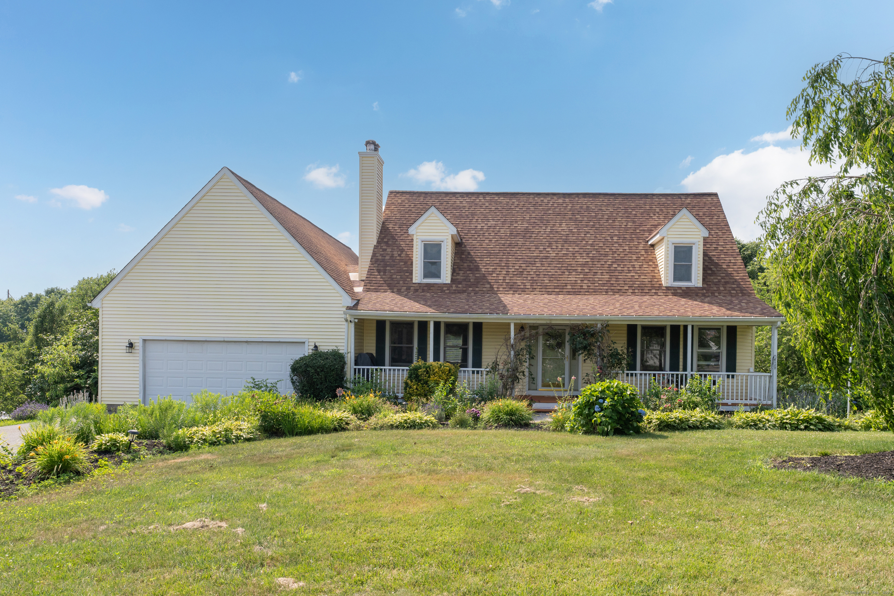 a front view of a house with garden