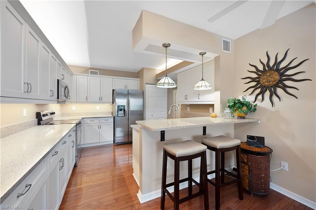 a kitchen with a table chairs sink and cabinets