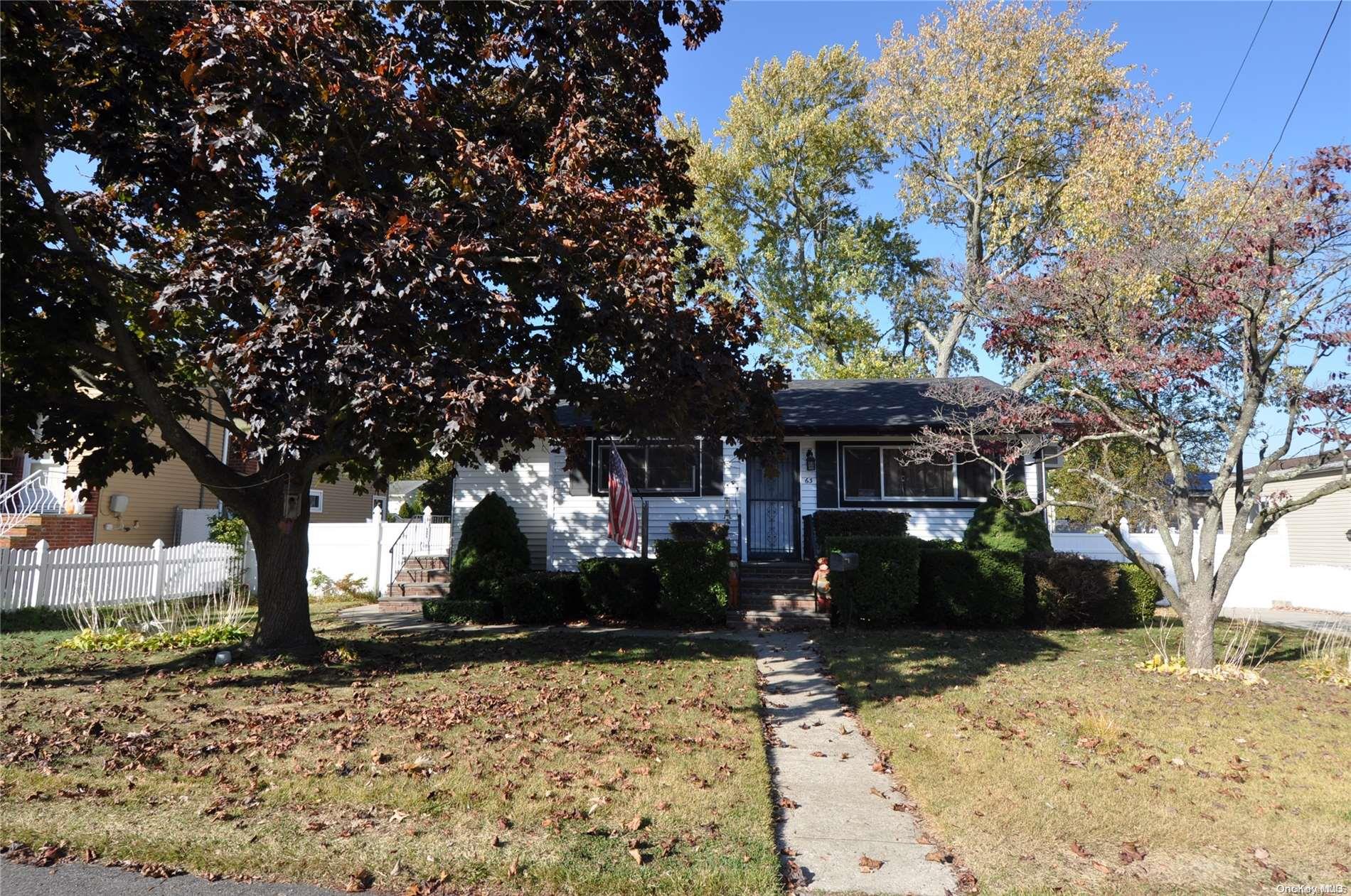 a front view of a house with a yard covered in snow