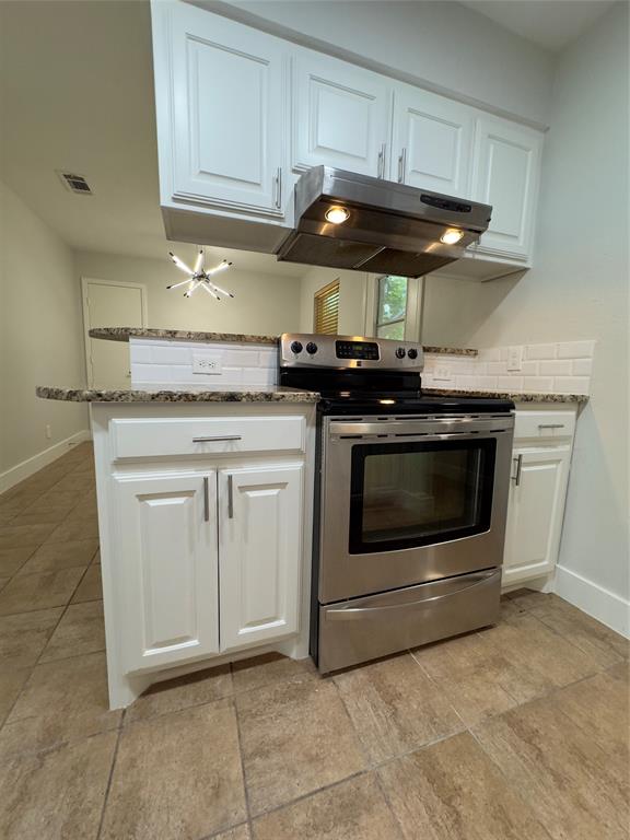 a kitchen with stainless steel appliances granite countertop a stove and a sink