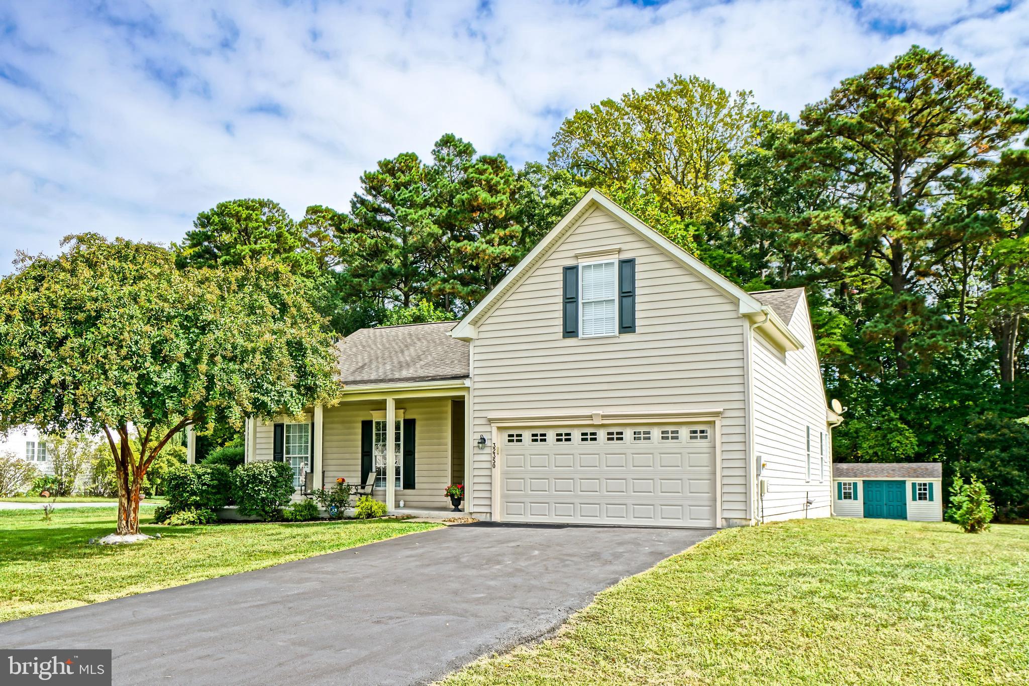 a view of a house with a yard and potted plants