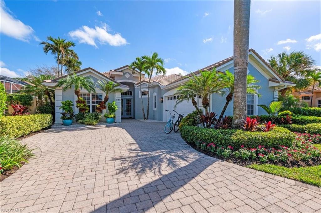 Mediterranean / spanish-style home with a garage