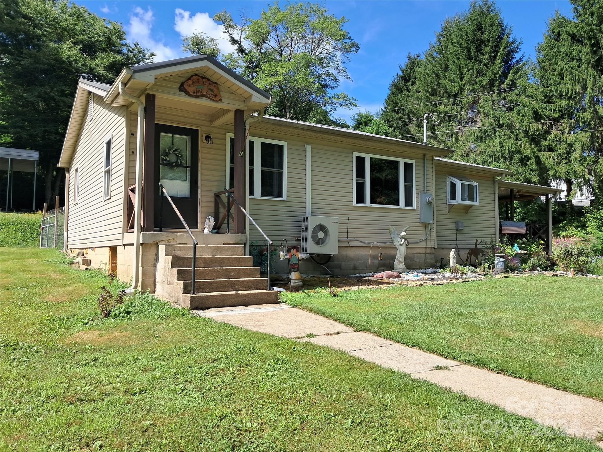 a front view of house with yard and green space