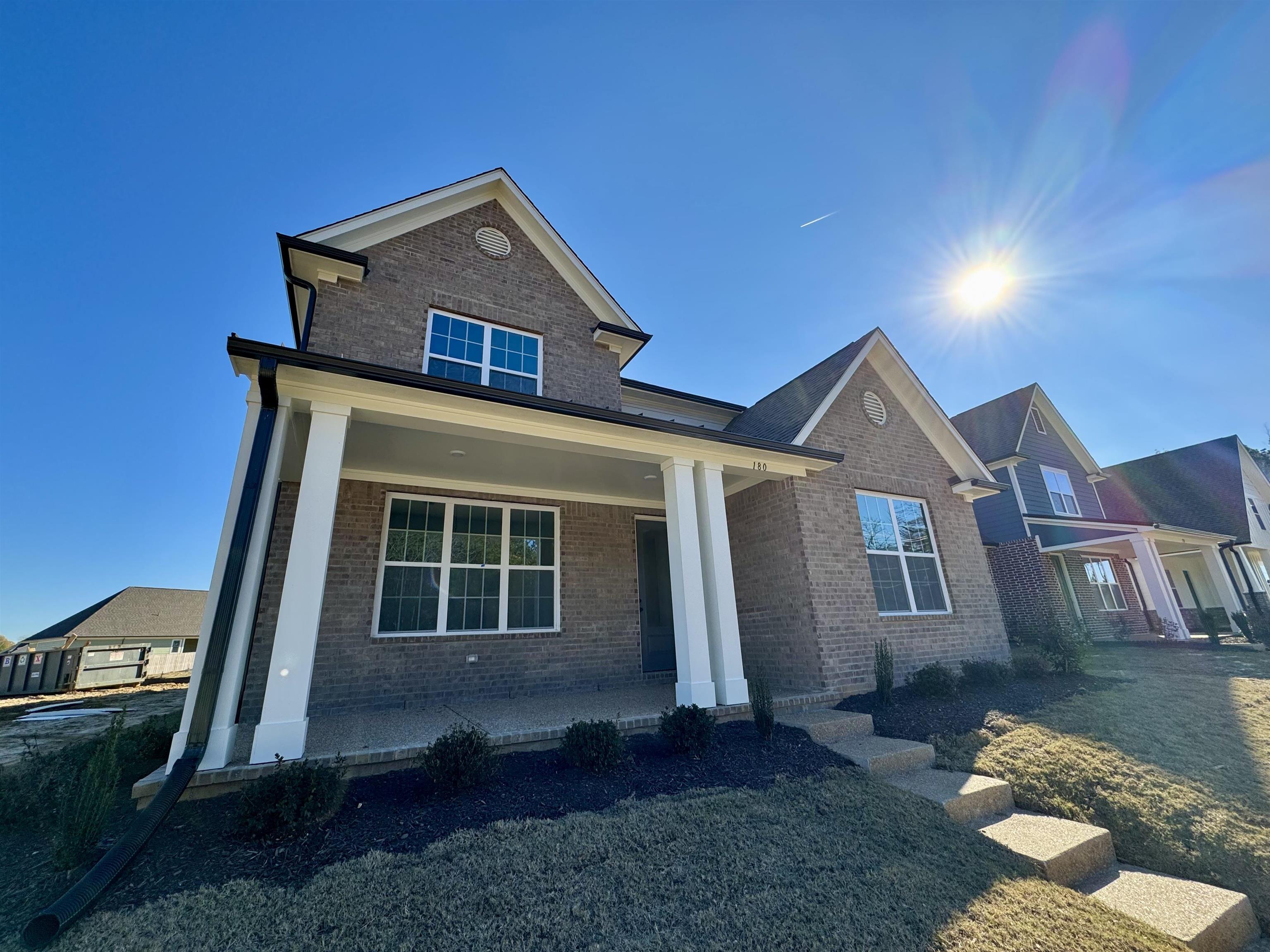 View of front of property with a porch and a front lawn