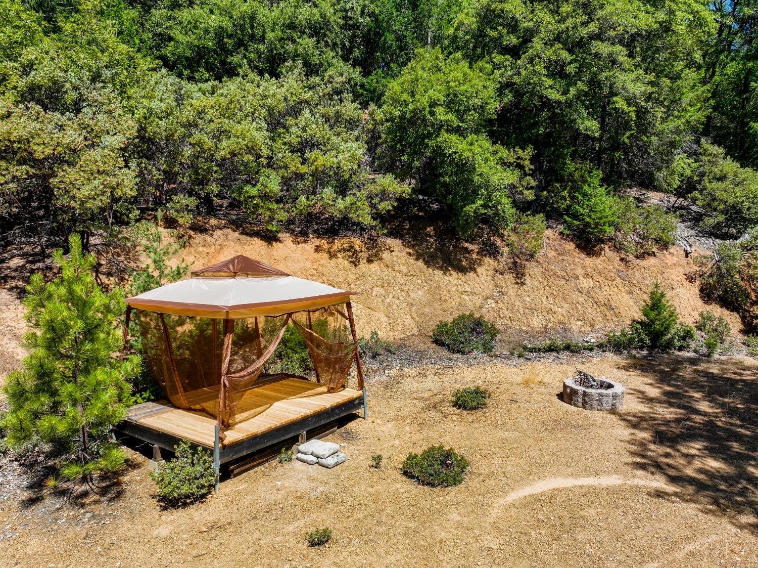 a view of backyard with a table and chairs under an umbrella