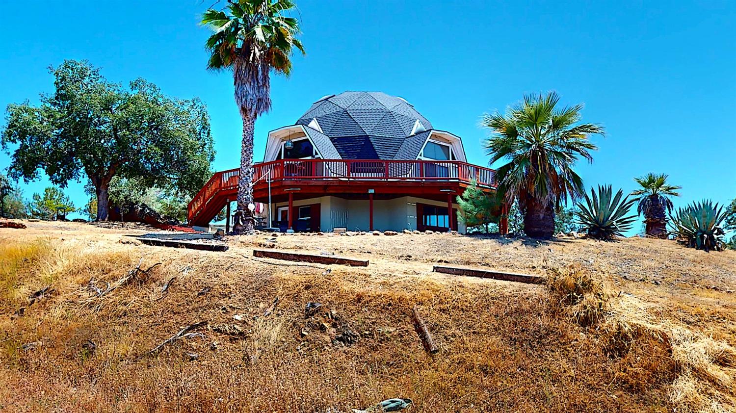 a view of a house with a swimming pool and a trees