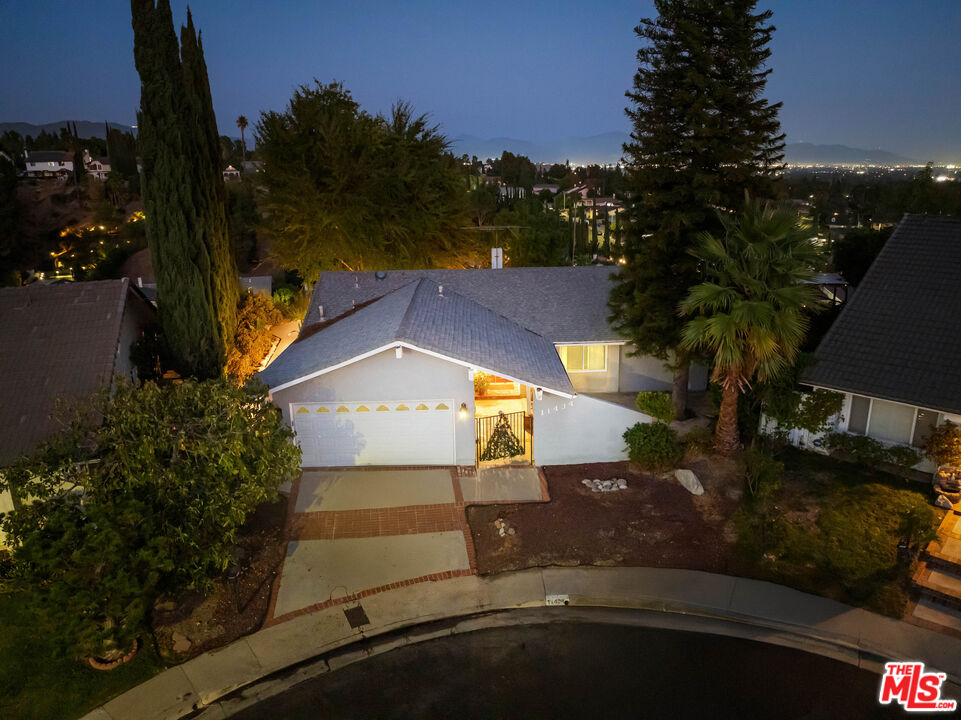 an aerial view of a house with a yard basket ball court and outdoor seating