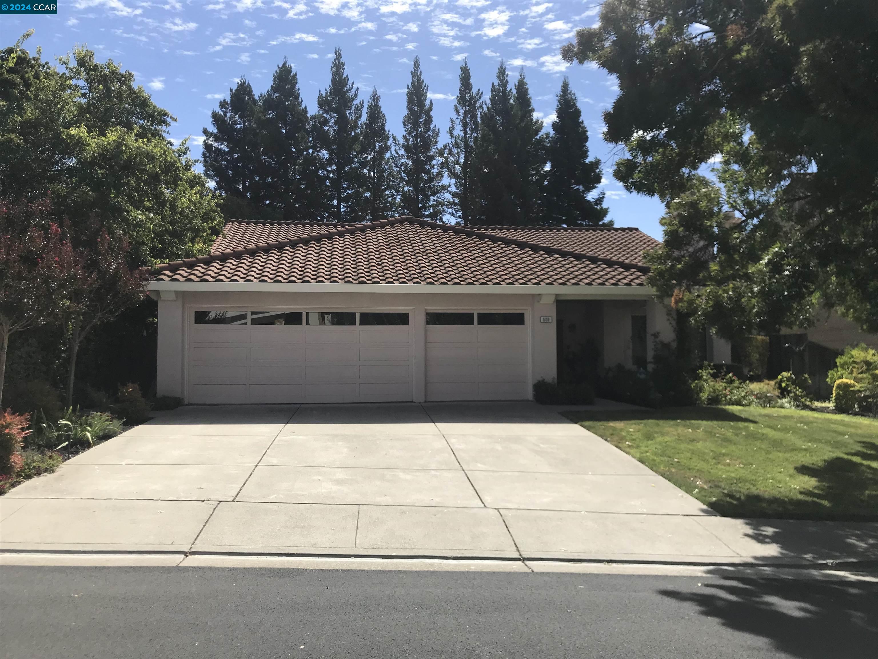 a front view of a house with a garden