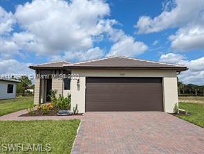 View of front of property with a front lawn and a garage