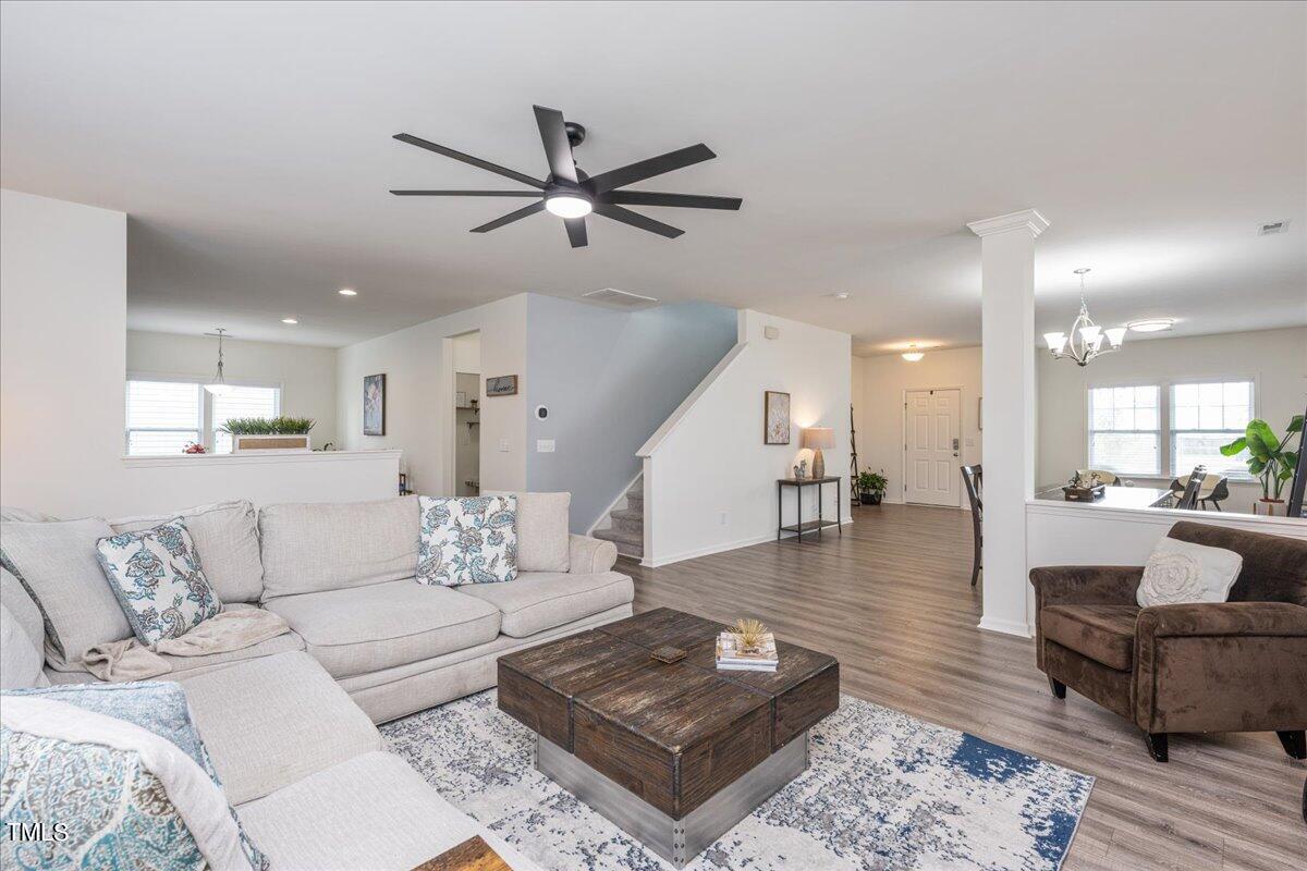 a living room with furniture and a wooden floor