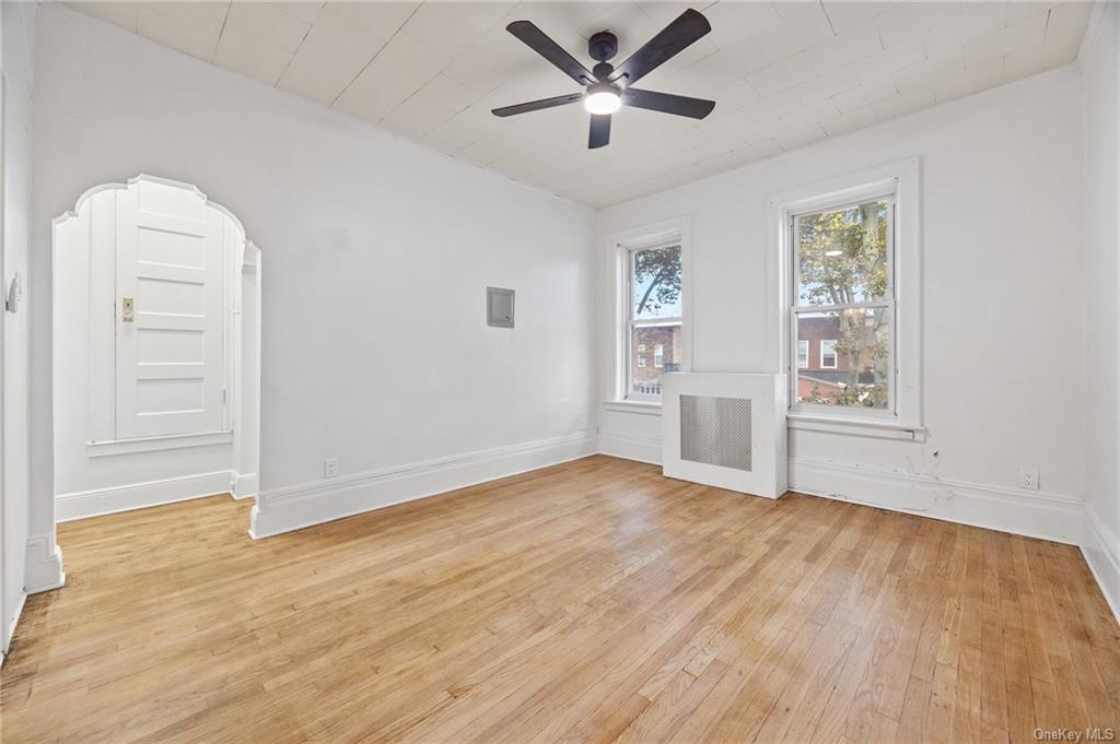 Spare room with light hardwood / wood-style floors and ceiling fan