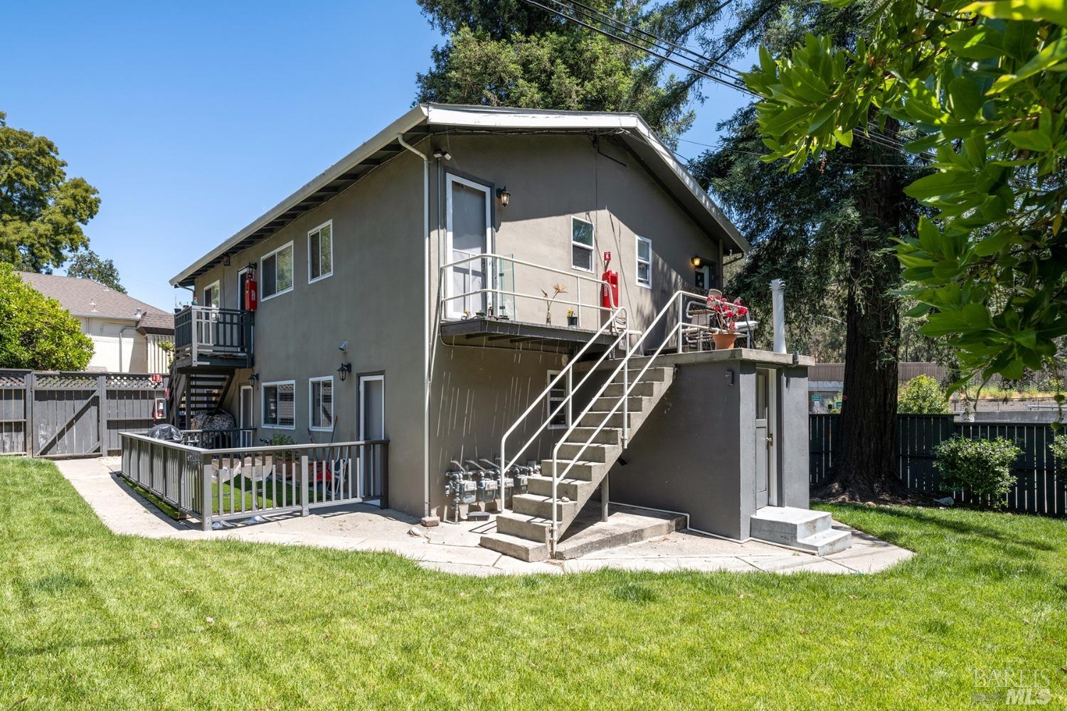 a view of a house with wooden fence