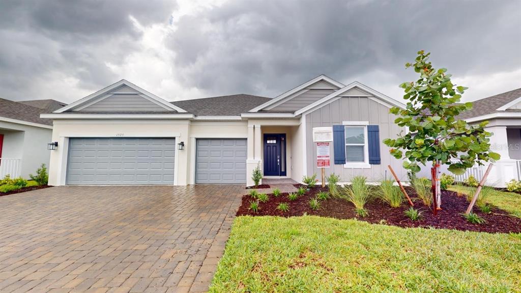 a front view of a house with a yard and garage