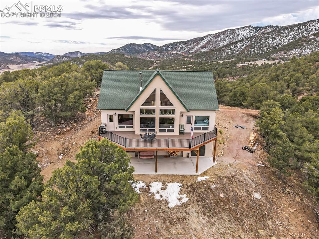 Front of property featuring a deck with mountain view