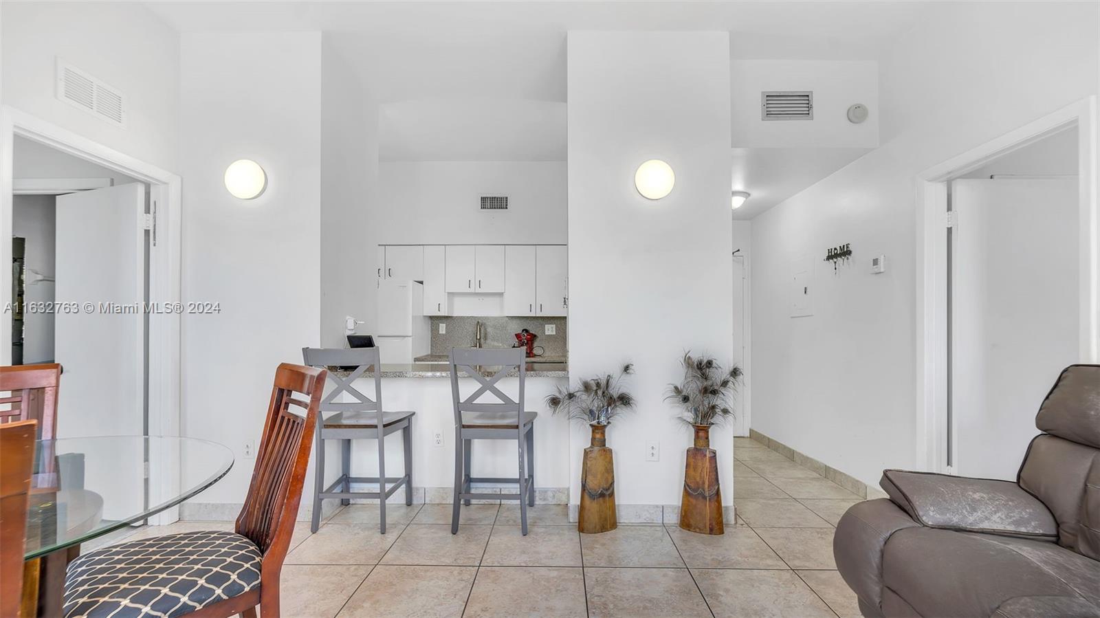 a living room with furniture a rug and a chandelier