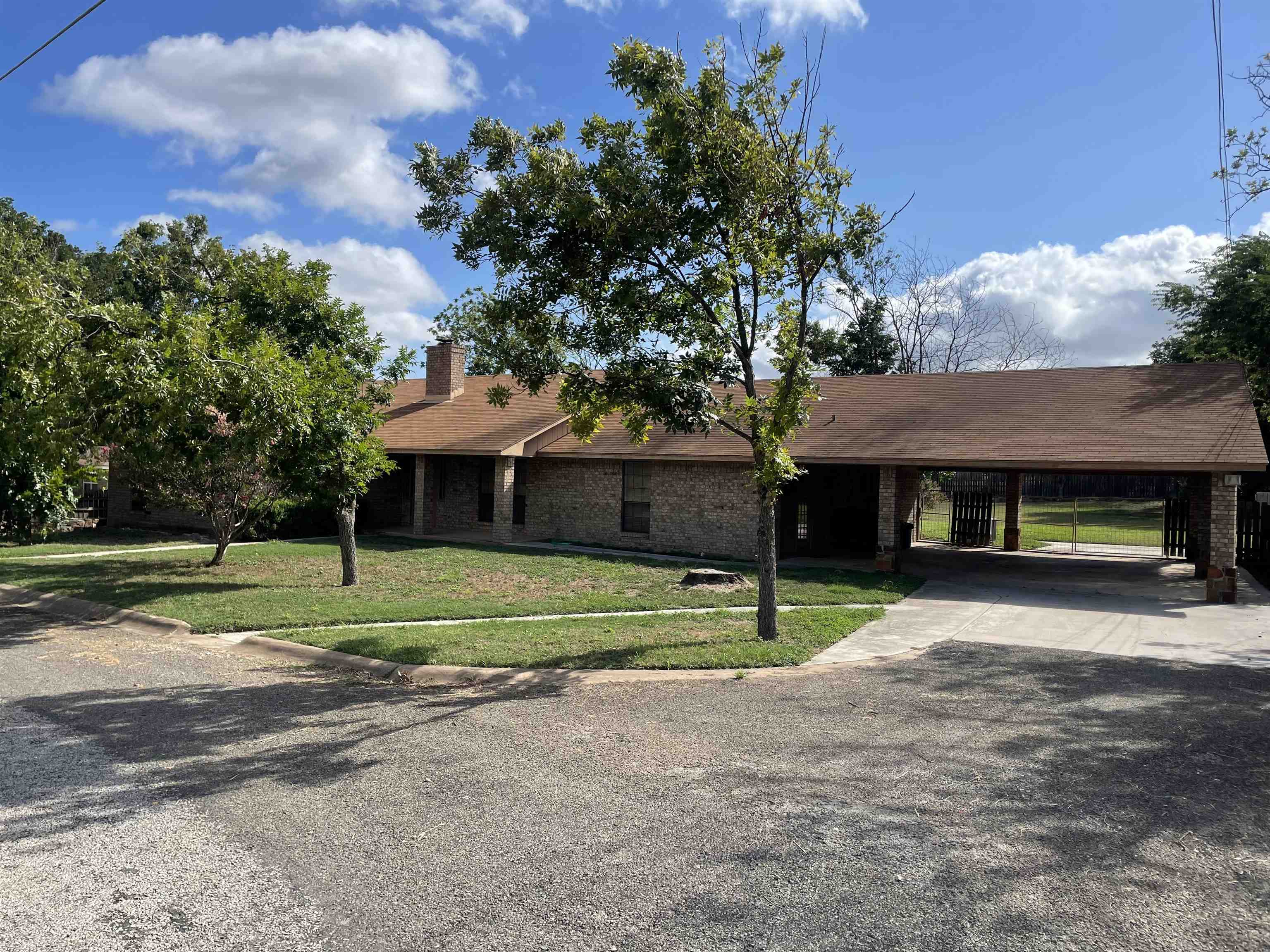 a view of a house with a yard and tree s