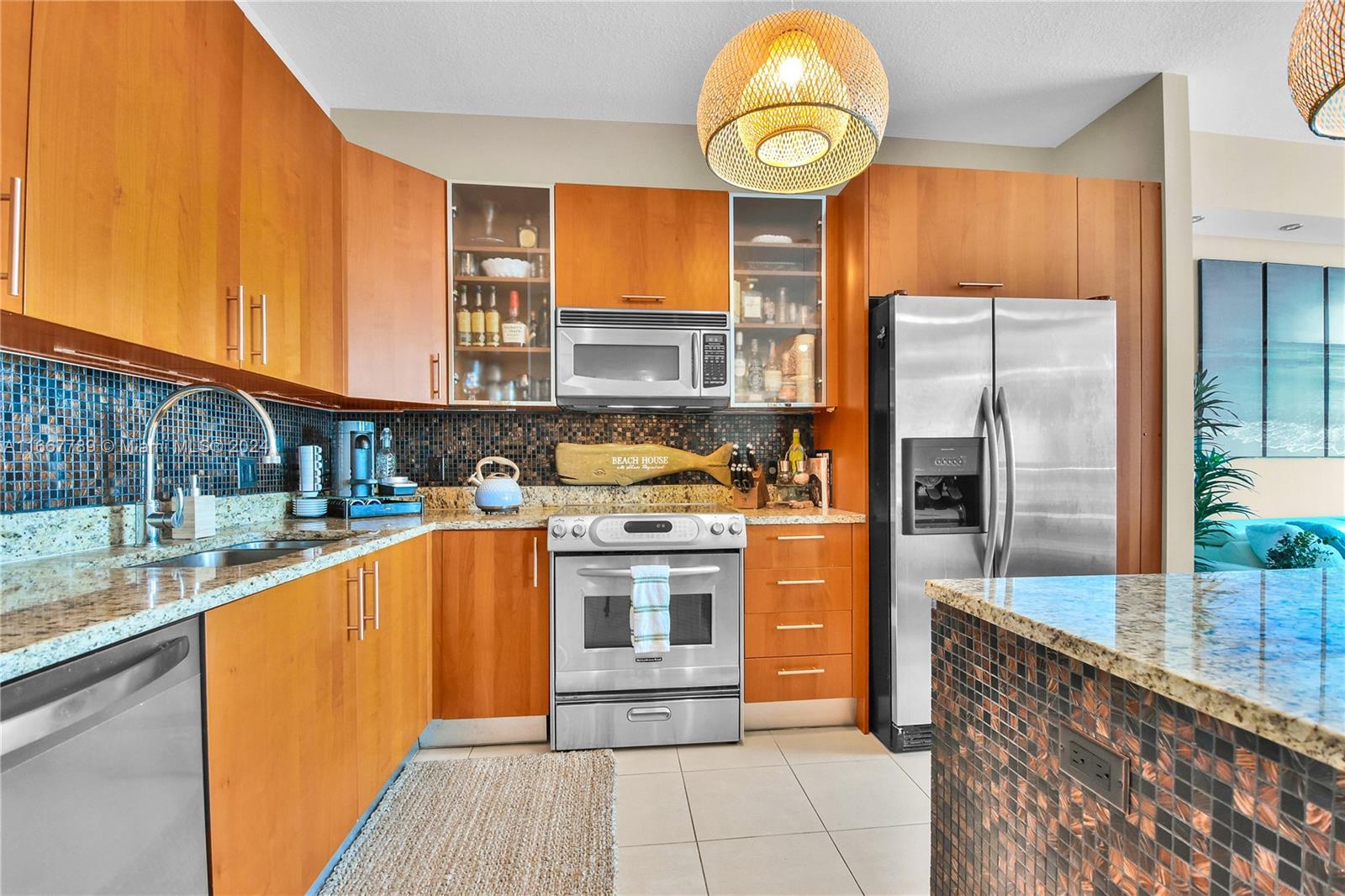 a kitchen with stainless steel appliances granite countertop a stove a sink and a refrigerator