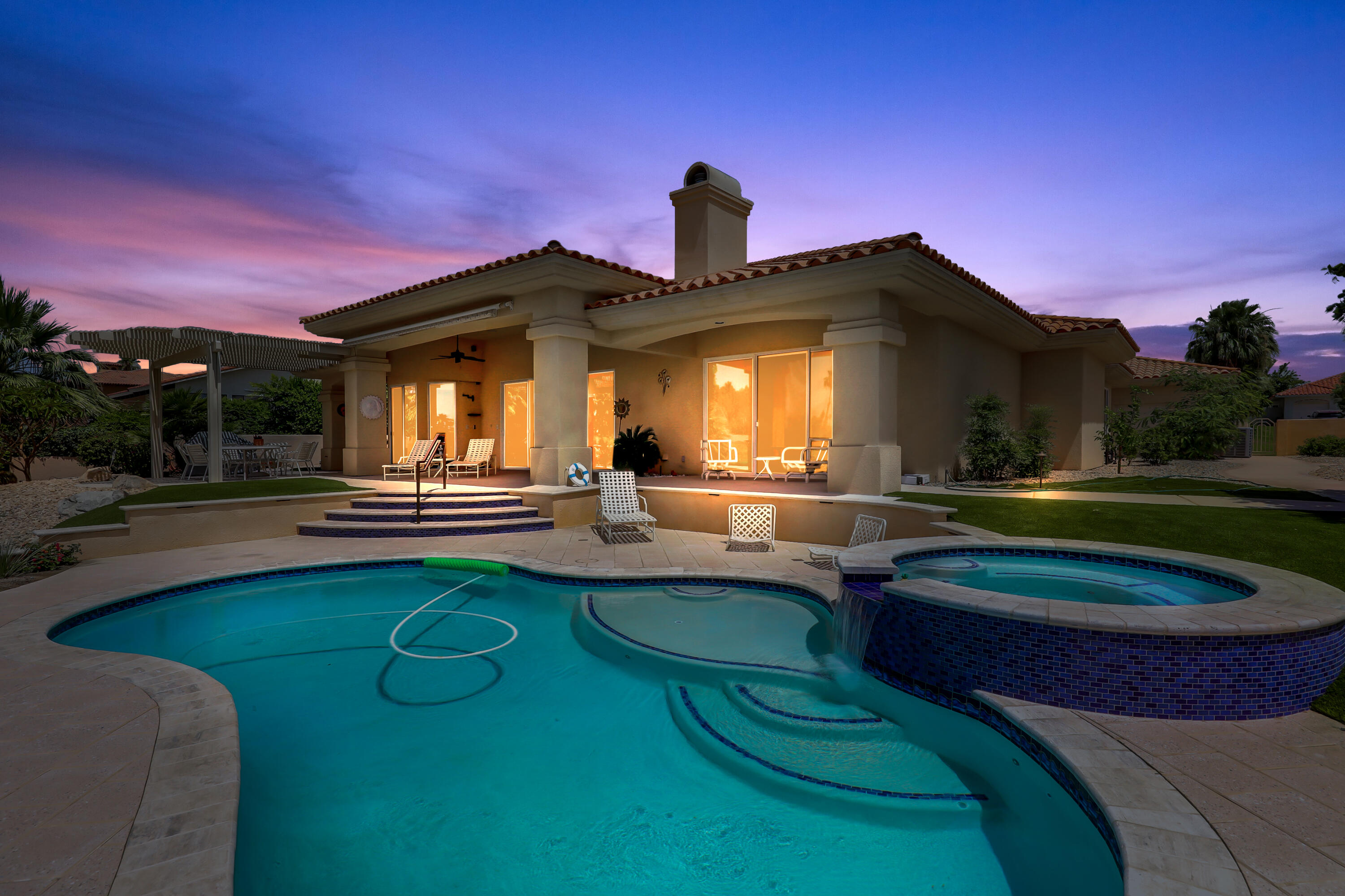 a front view of a house with swimming pool yard and outdoor seating