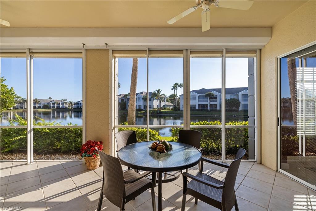 a view of a porch with furniture and a yard