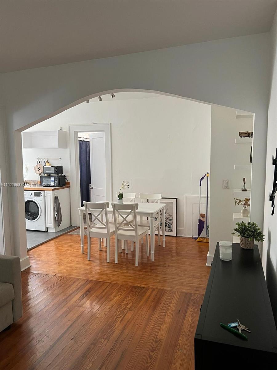 a view of a dining room with furniture and wooden floor