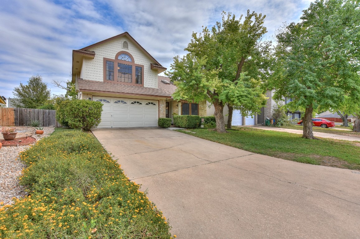 a front view of a house with a yard and garage