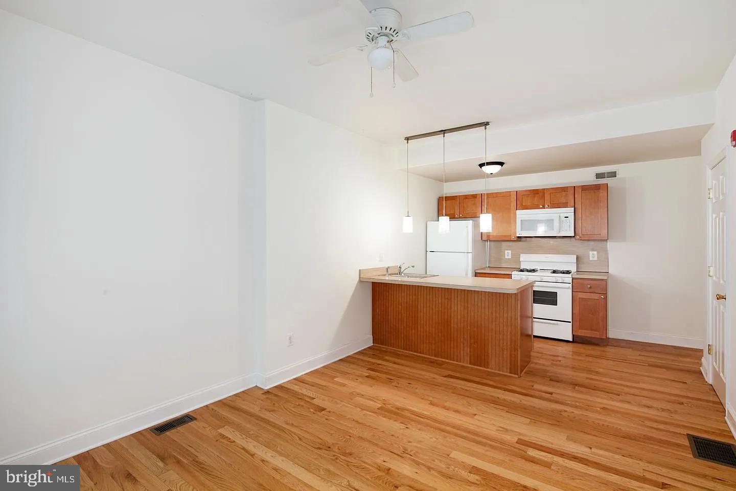 a view of kitchen with wooden floor