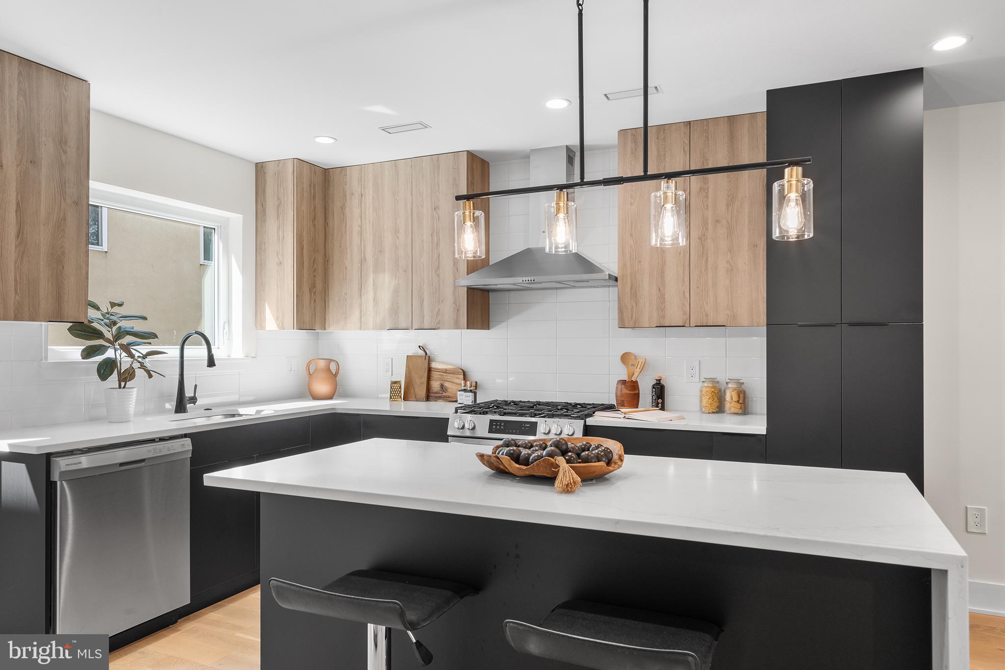 a kitchen with a sink a stove and chairs