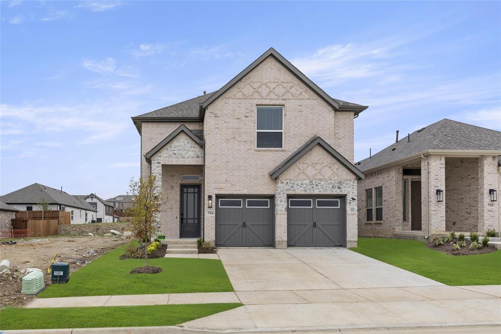 a view of a house with a yard and garage