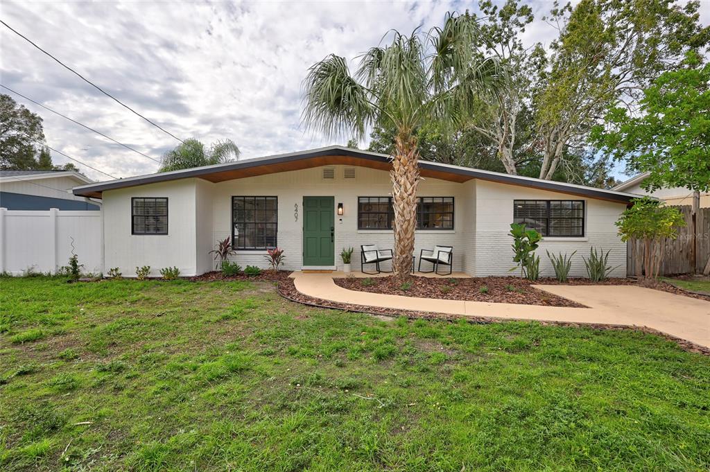 a front view of house with yard and green space