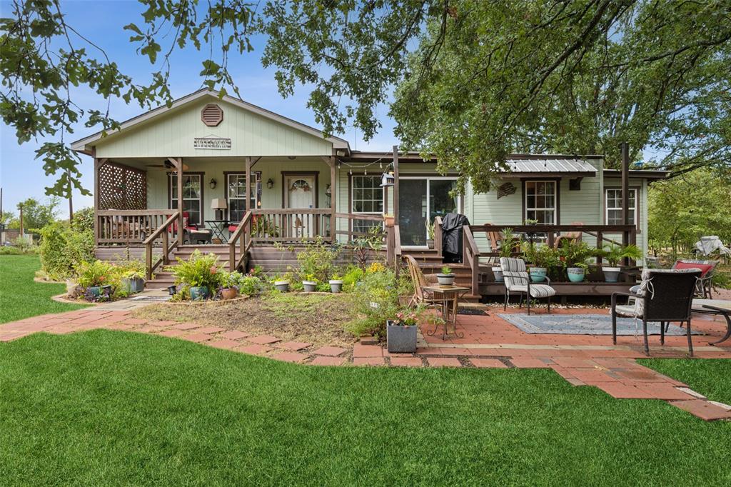 a front view of a house with garden and sitting area