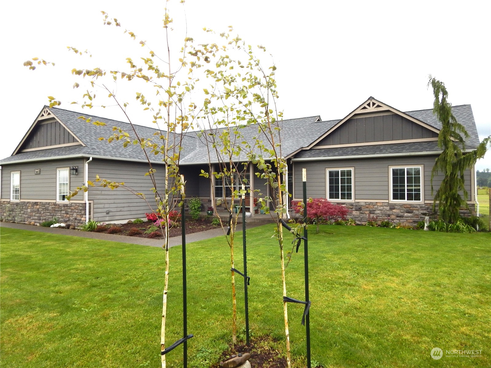 a front view of a house with a garden