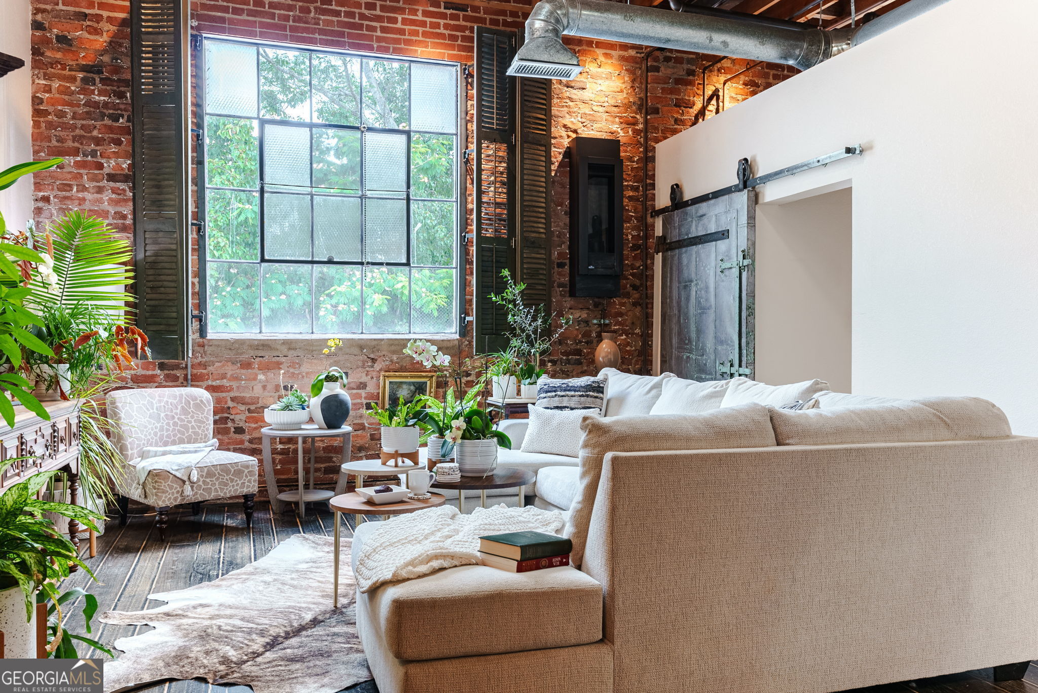 a living room filled with furniture and a potted plant