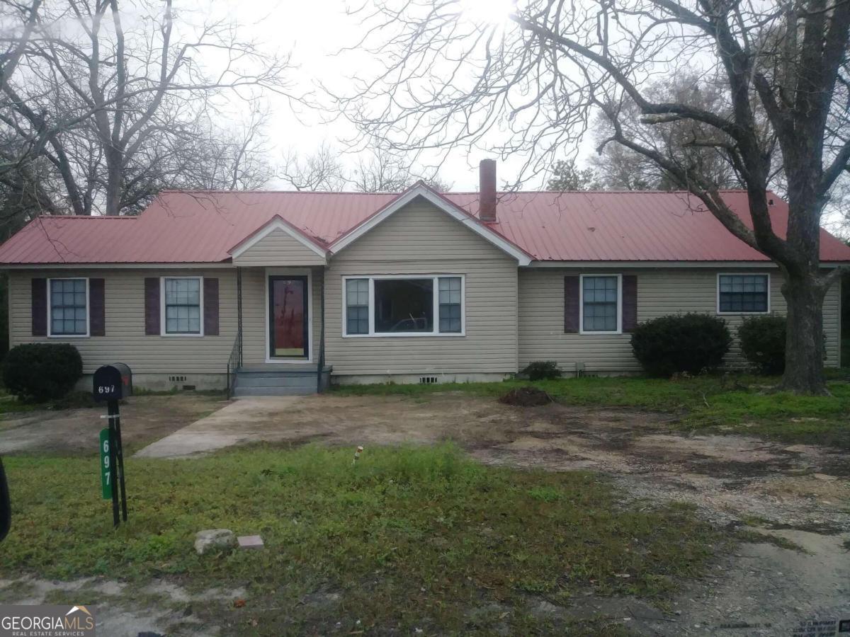 a house that has a tree in front of it