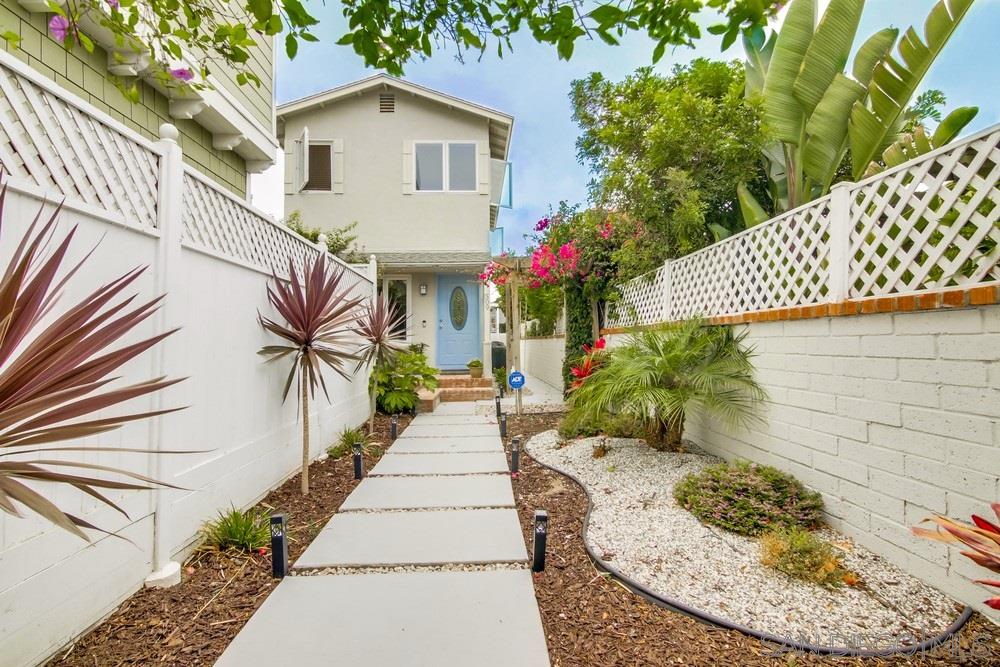 a front view of a house with a garden