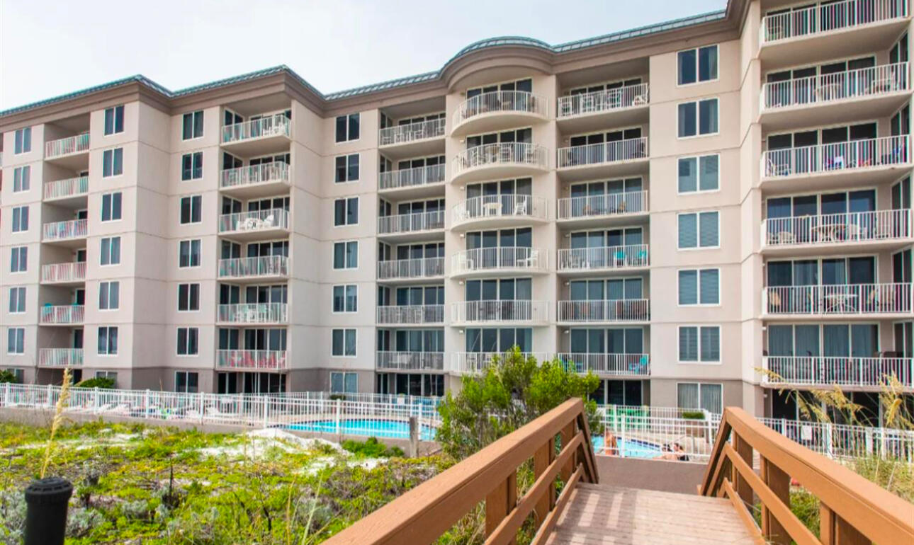 a front view of a building with a swimming pool