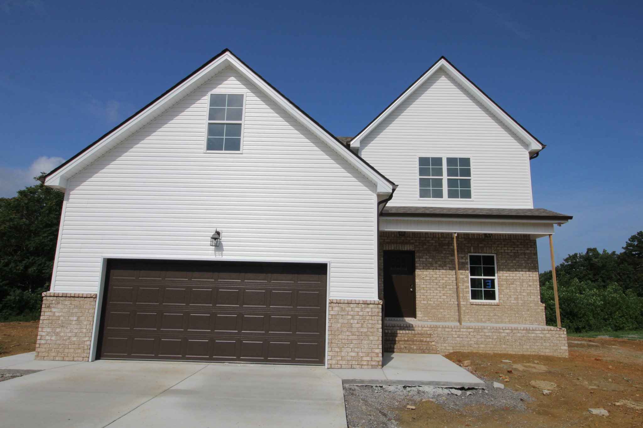 a front view of a house with garage