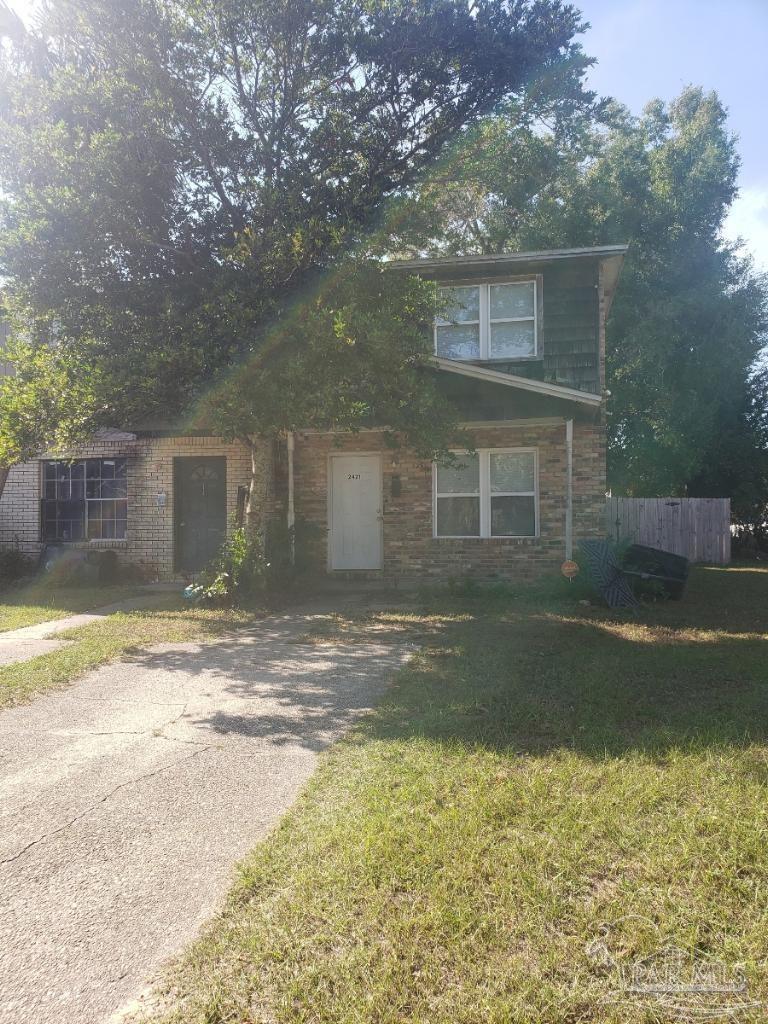 a view of a house with a yard