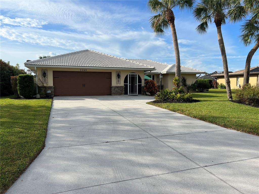 a front view of a house with a garden and yard