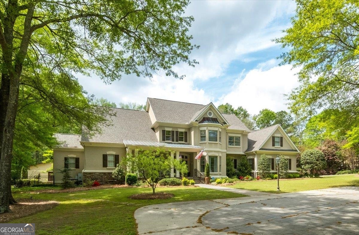 a front view of a house with a garden