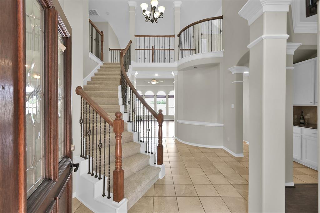 a view of staircase with lots of frames and a rug