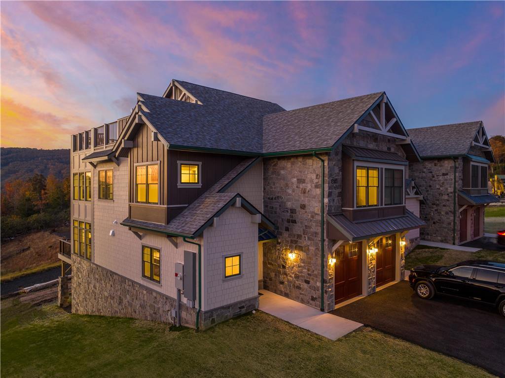 a view of a big house with a big yard and large tree