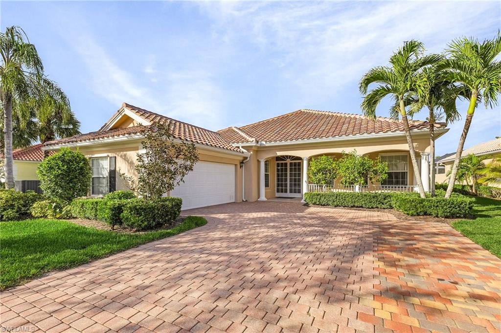 Mediterranean / spanish-style house with covered porch and a garage