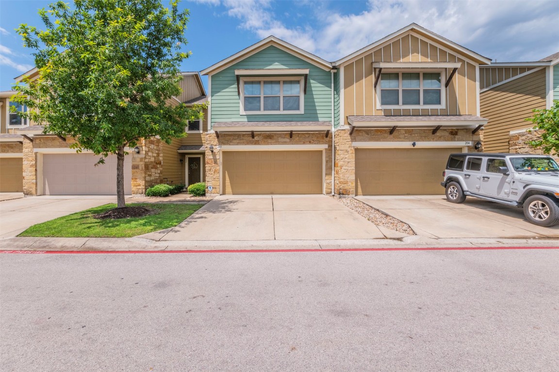 a front view of a house with a yard and garage