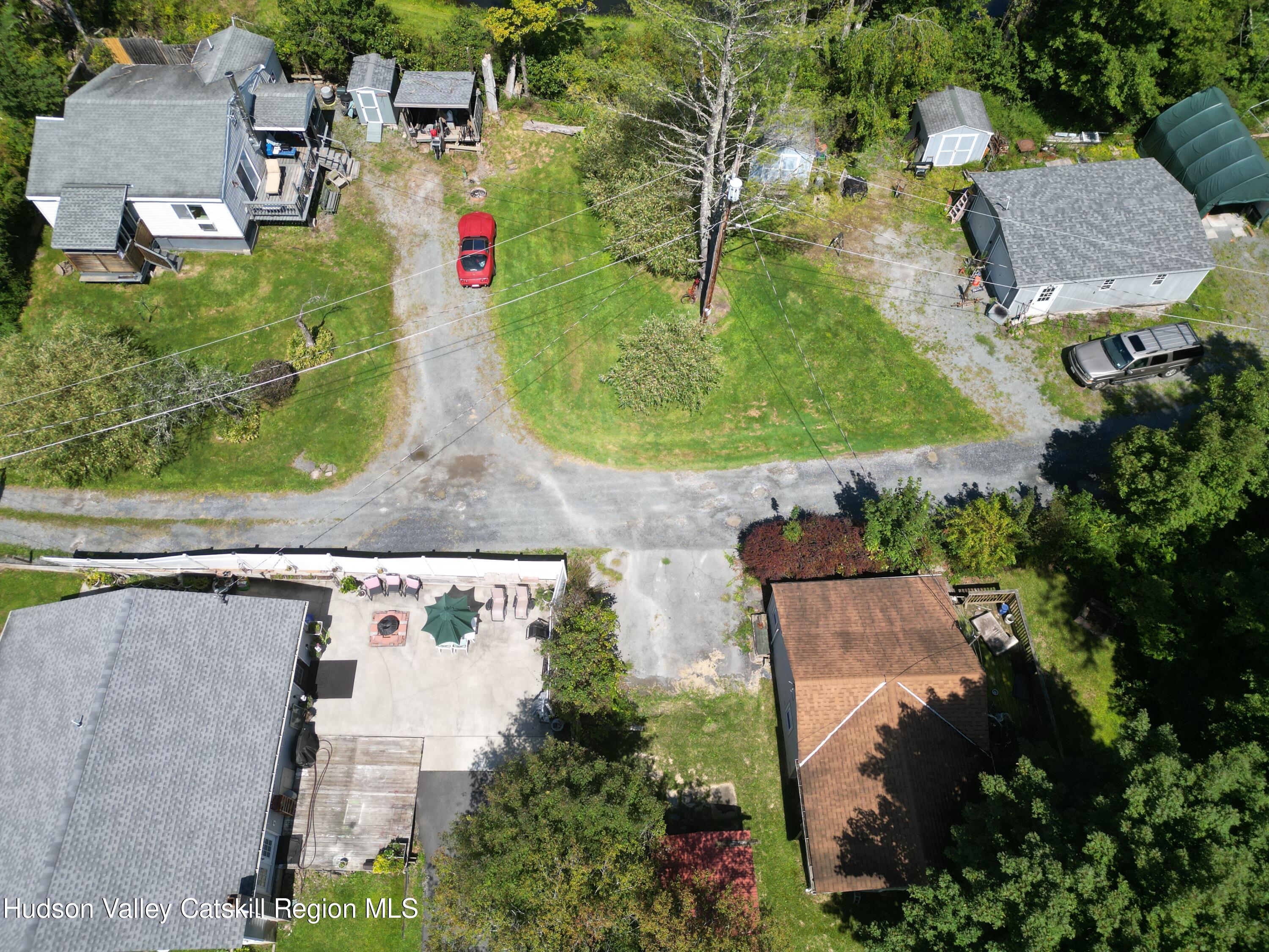 an aerial view of residential houses with outdoor space and street view