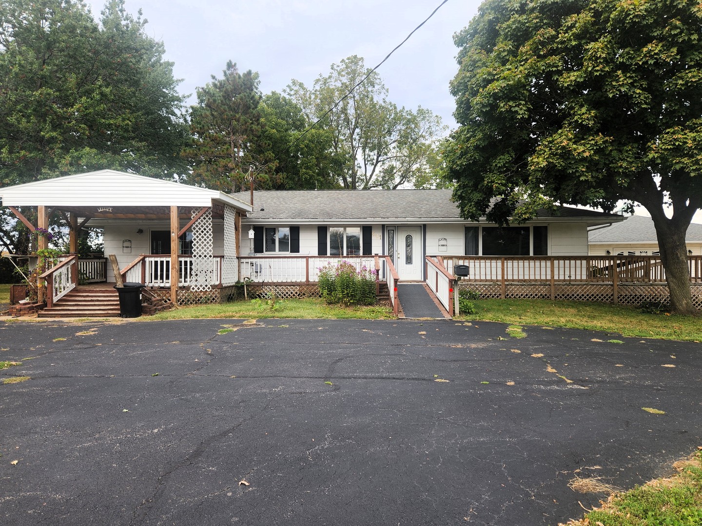 a view of a house with a yard and sitting area