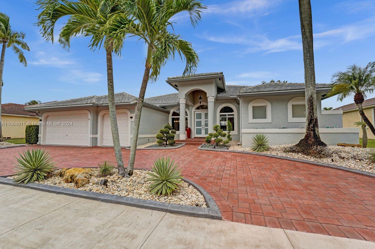 Wide circular driveway newly resurfaced and resealed! Impact windows/doors, outdoor lighting, beautiful curb appeal