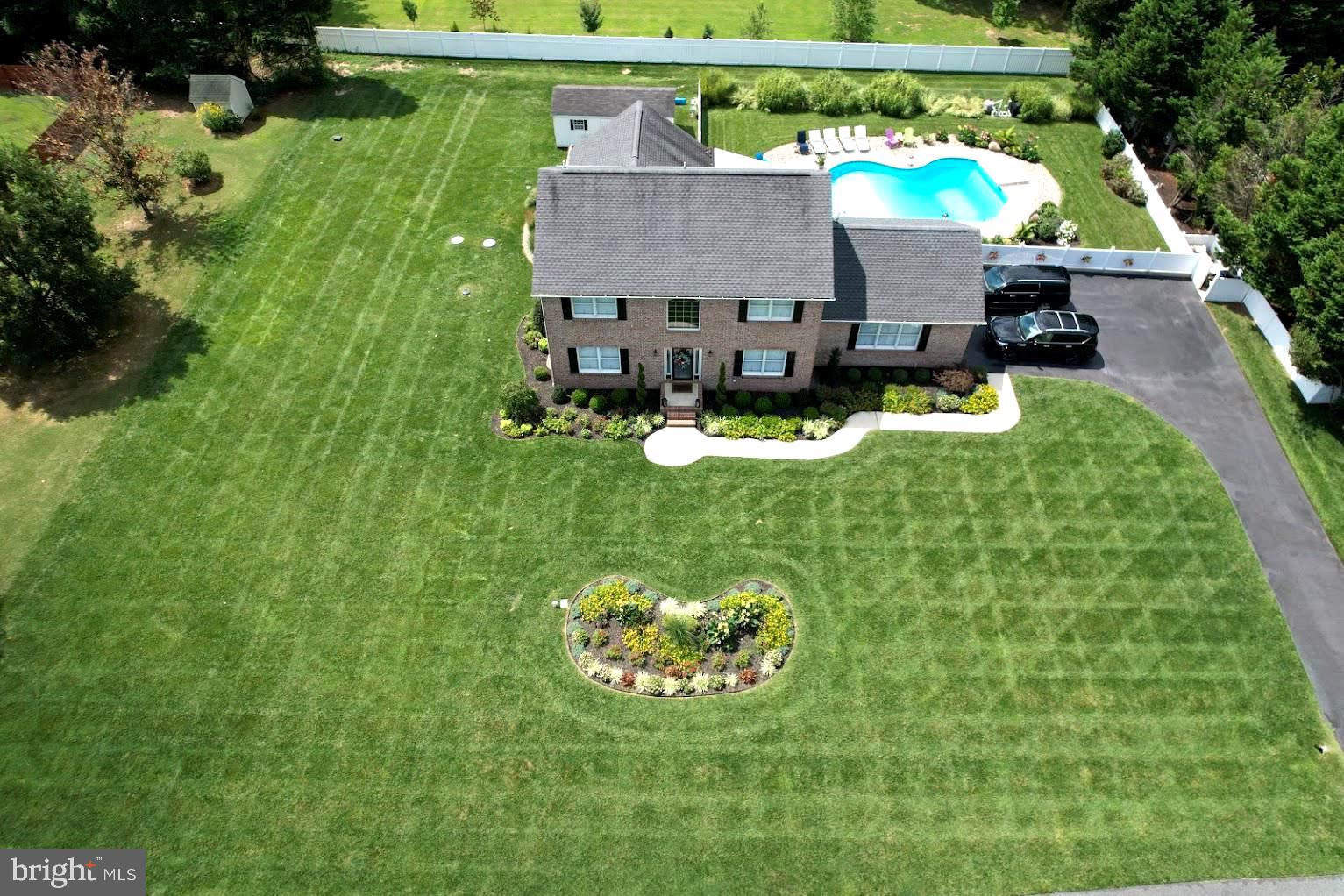 a view of house with backyard outdoor seating and green space